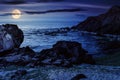 number of stones and rock on the sandy sea coast at night Royalty Free Stock Photo